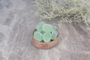 Bowl of marmalade candies on stone background.