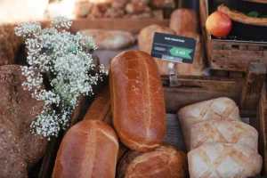 Rustic loaves baked bread with tag and gypsophila flowers