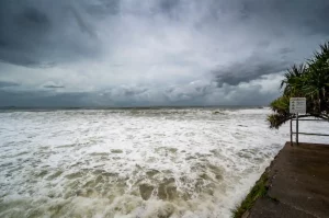 Foamy sore under dark cloudy skies in Alexandra Headland Beach, Queensland Australia